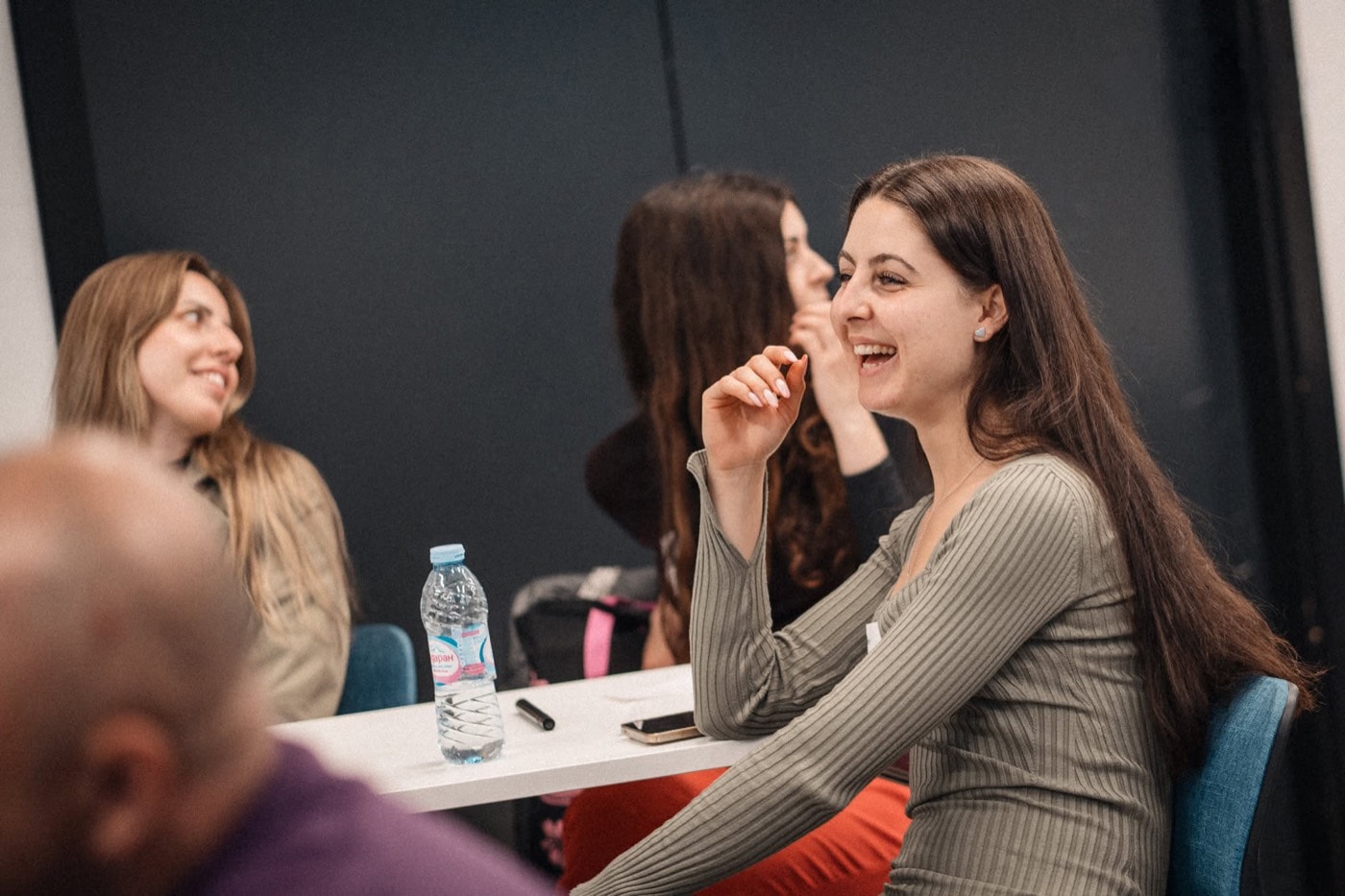 Participants laughing while working together during a session