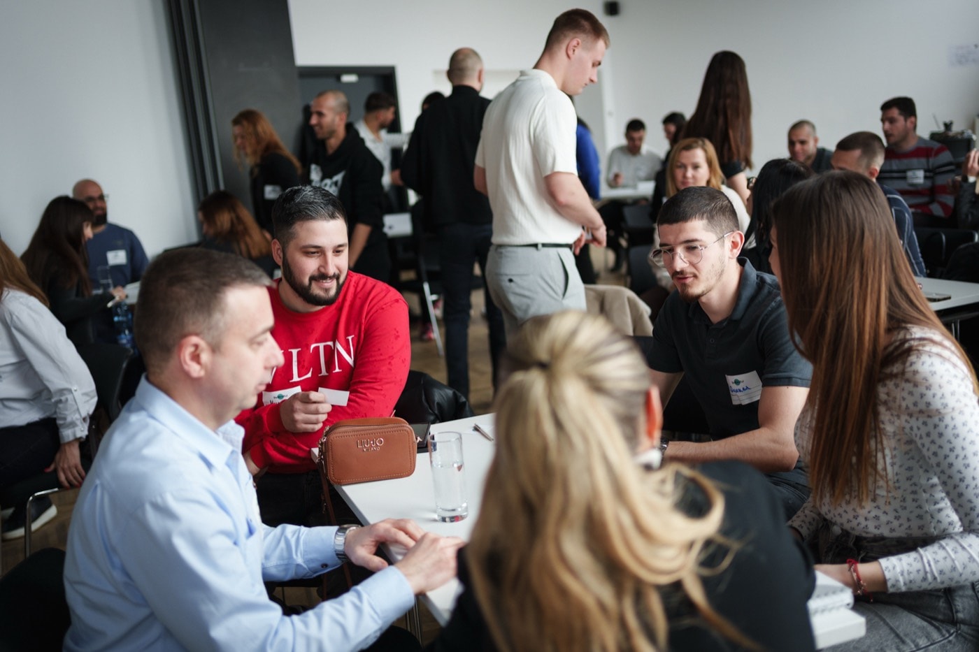 Participants working on a task in small groups around the tables